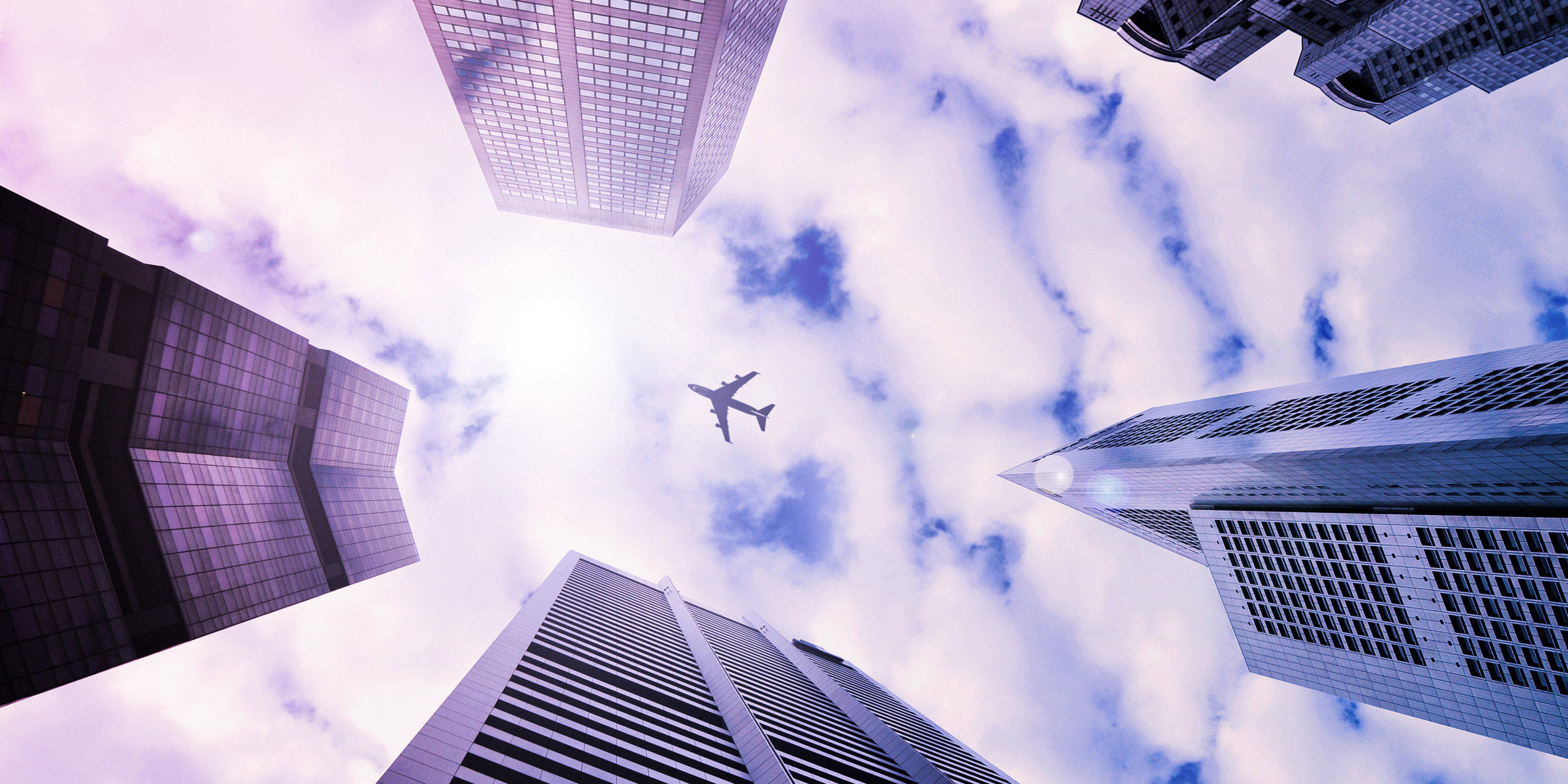 Flying airplane with skyscrapers in front