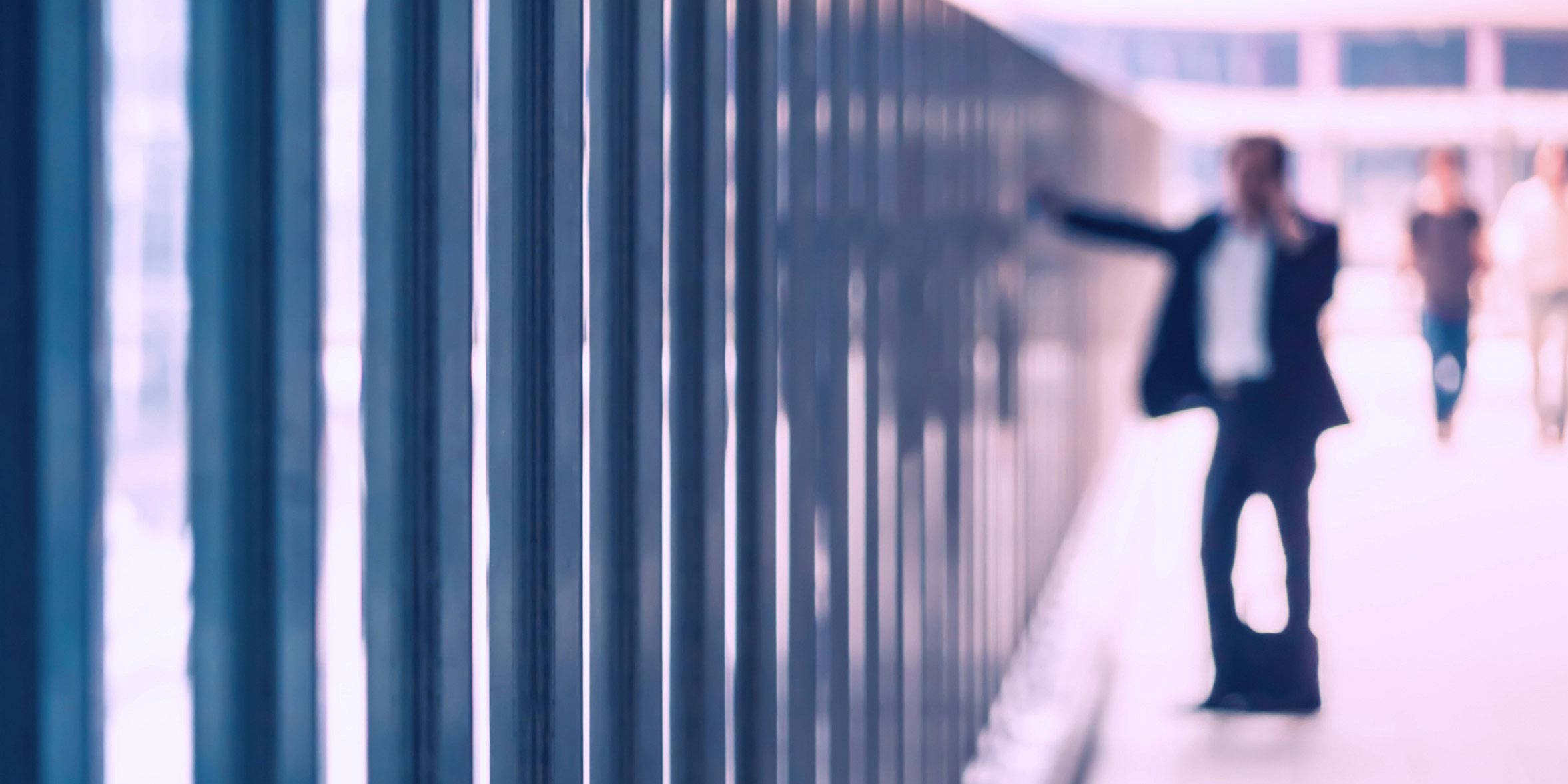 Blurred business man on the phone inside modern building